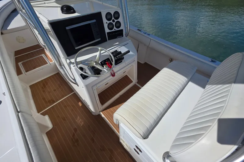 Slide: The Image of 2002 Regulator 26 Center Console boat interior with steering wheel and seating. - 15