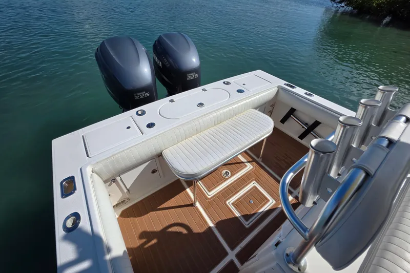 Slide: The Image of 2002 Regulator 26 Center Console boat with twin Yamaha 225 engines on calm water. - 11