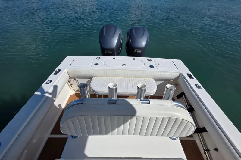 Slide: The Image of 2002 Regulator 26 Center Console boat with twin Yamaha 225 engines on calm water. - 13