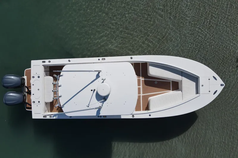 Slide: The Image of Overhead view of 2002 Regulator 26 Center Console boat on clear water. - 8
