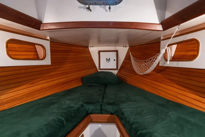 Slide: The Image of Cozy cabin interior of 1981 Morris Yachts Leigh 30 with wooden paneling and green cushions. - 19