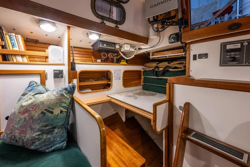 Slide: The Image of Cozy interior of 1981 Morris Yachts Leigh 30 sailboat with wooden accents and nautical equipment. - 25