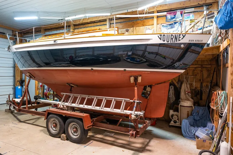 Slide: The Image of 1981 Morris Yachts Leigh 30 sailboat named "Journey" on a trailer in a garage. - 28