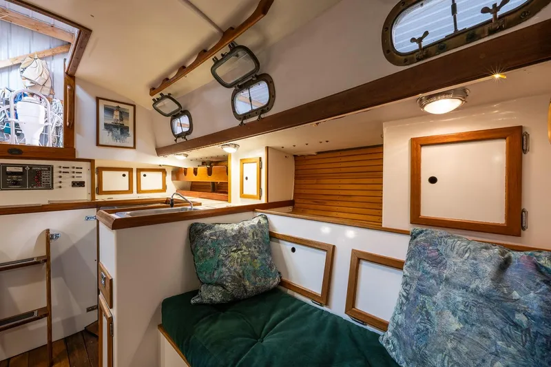 Slide: The Image of Interior of 1981 Morris Yachts Leigh 30, featuring cozy seating and nautical decor. - 17