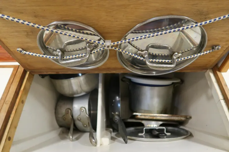 Slide: The Image of Storage area with pots and lids on a 1981 Morris Yachts Leigh 30. - 32