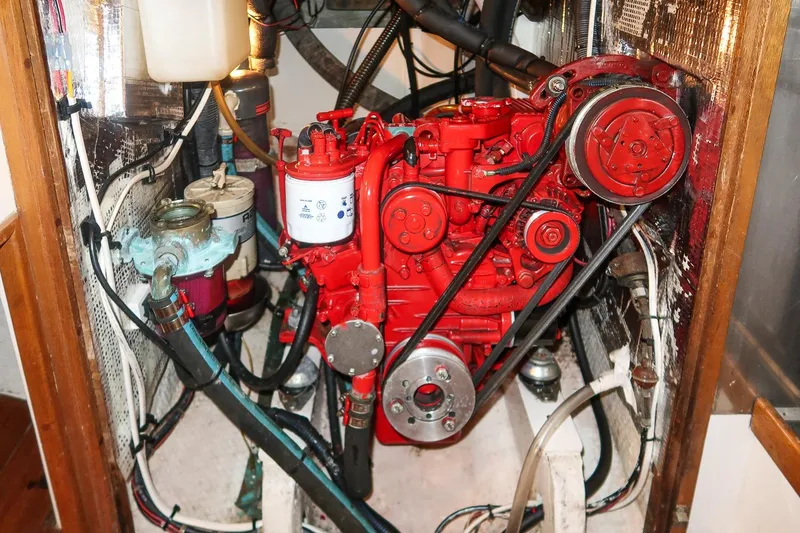 Slide: The Image of Engine compartment of a 1981 Morris Yachts Leigh 30, featuring a red marine engine. - 31