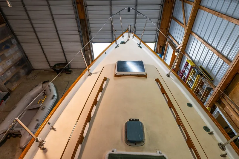 Slide: The Image of 1981 Morris Yachts Leigh 30 sailboat in a wooden boathouse, viewed from above. - 5