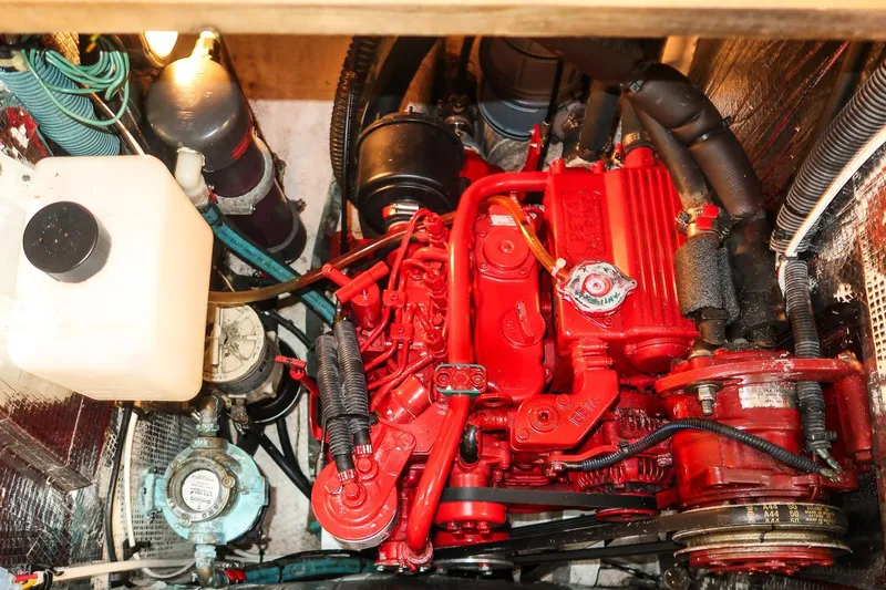 Slide: The Image of Engine compartment of a 1981 Morris Yachts Leigh 30, featuring a red marine engine. - 30