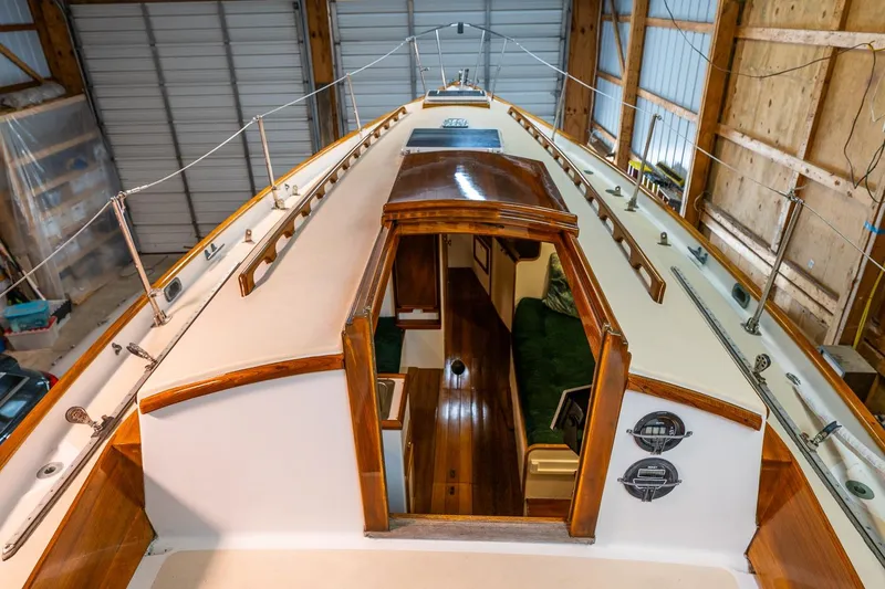 Slide: The Image of 1981 Morris Yachts Leigh 30 sailboat interior with wooden accents in a storage shed. - 12