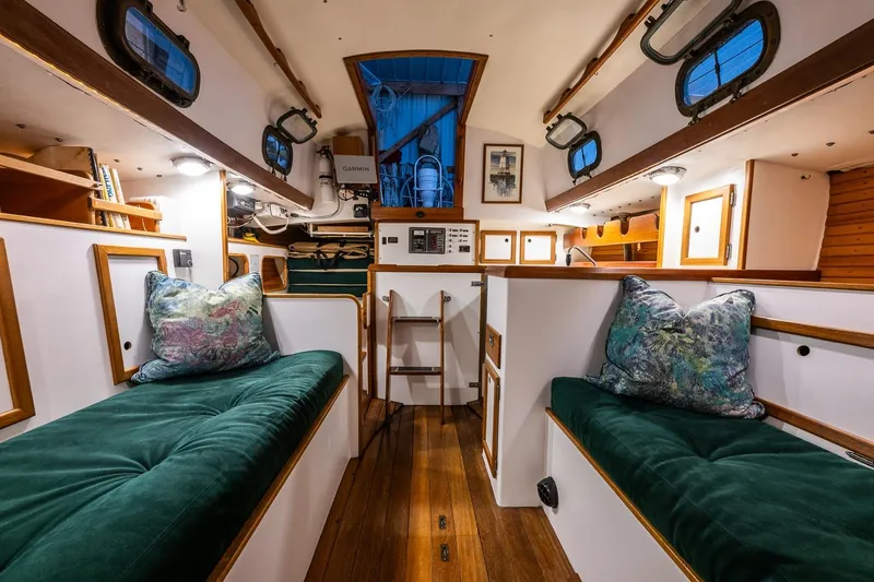 Slide: The Image of Interior of 1981 Morris Yachts Leigh 30, featuring cozy seating and nautical decor. - 24