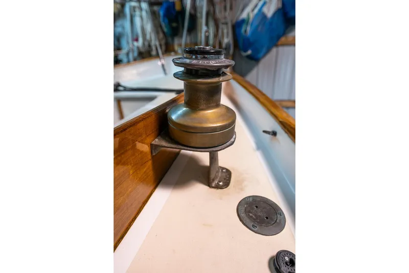 Slide: The Image of Winch on 1981 Morris Yachts Leigh 30 sailboat deck, featuring wooden trim. - 34