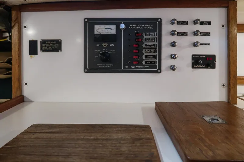 Slide: The Image of Control panel of a 1981 Morris Yachts Leigh 30, featuring switches and gauges. - 29
