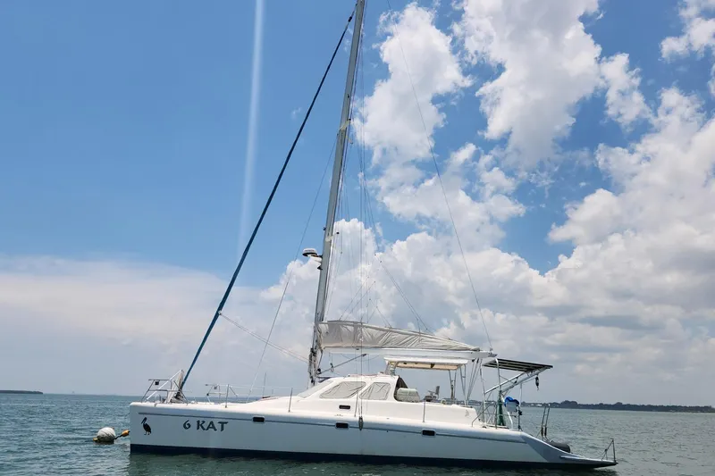 The Image of Sailing yacht Voyage Yachts Norseman 430, 1999 model, on calm waters under a blue sky. - 1