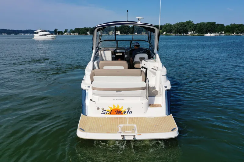 Slide: The Image of 2017 Regal 30 Express boat named "Sol-Mate" on a serene lake. - 8