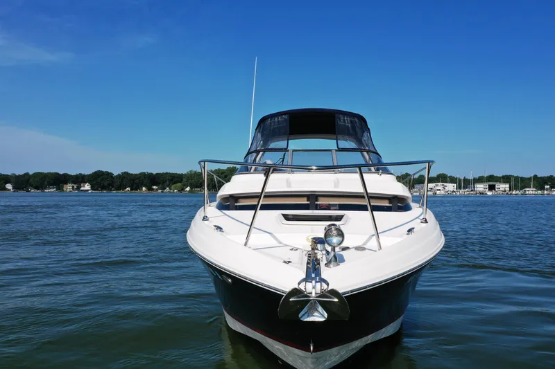 Slide: The Image of 2017 Regal 30 Express boat on calm water under clear blue sky. - 6