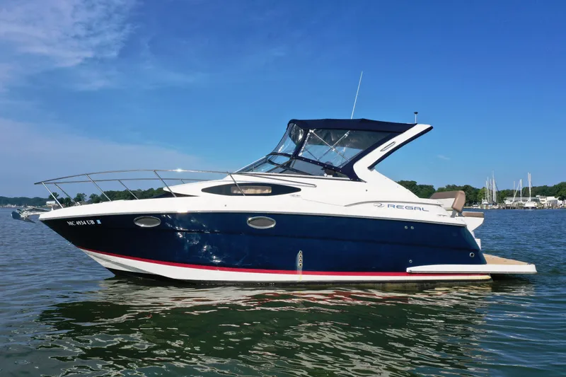 Slide: The Image of 2017 Regal 30 Express boat on calm water under clear blue sky. - 3