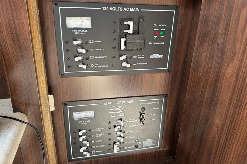 Slide: The Image of Control panel of a 2017 Regal 30 Express boat, featuring AC and DC power switches. - 25