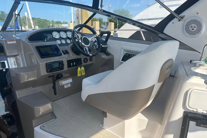 Slide: The Image of Cockpit of 2017 Regal 30 Express boat with steering wheel and control panel. - 15