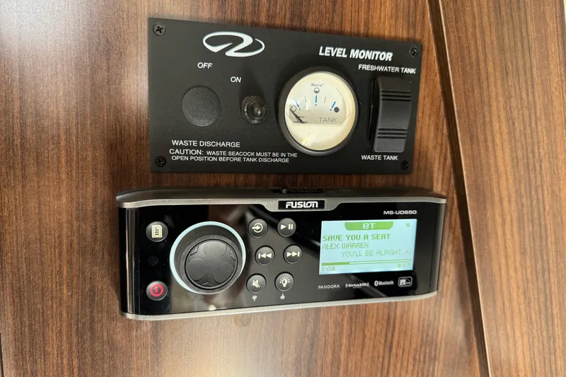 Slide: The Image of Control panel and stereo system on 2017 Regal 30 Express boat interior. - 24