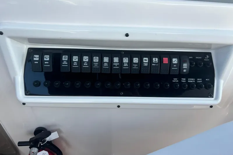 Slide: The Image of Control panel of a 2017 Regal 30 Express boat with labeled switches. - 17