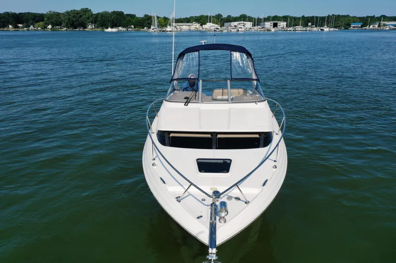 Slide: The Image of 2017 Regal 30 Express boat on calm water, front view. - 7