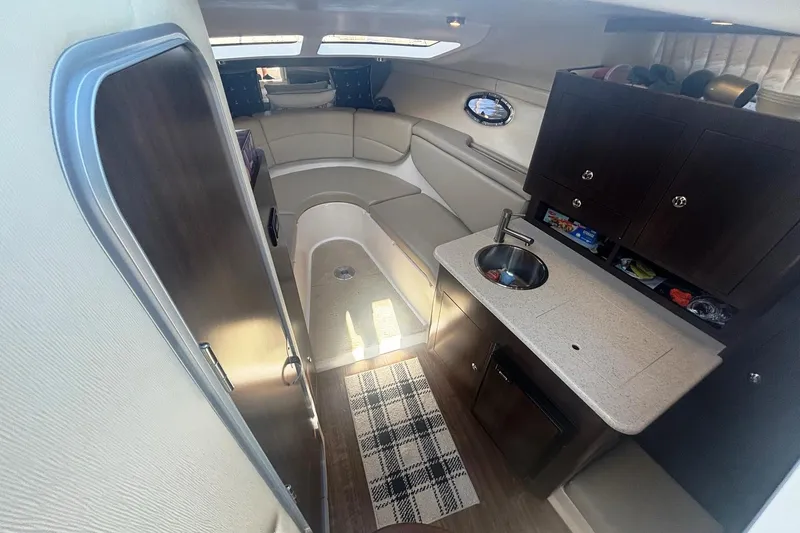 Slide: The Image of Interior of 2017 Regal 30 Express boat with kitchenette and seating area. - 18