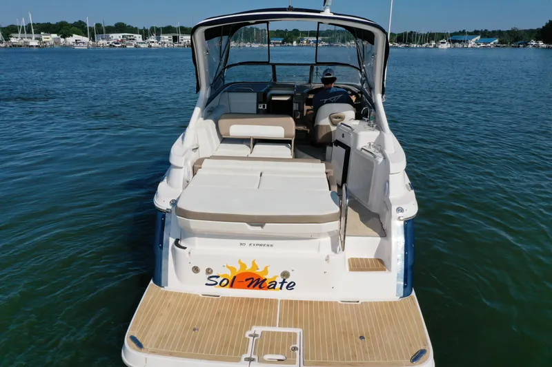 Slide: The Image of 2017 Regal 30 Express boat on water, rear view with "Sol-Mate" name. - 10