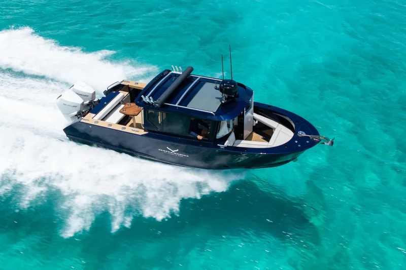 The Image of 2026 Jasper Marine Defender 22 cruising on clear turquoise waters. - 0