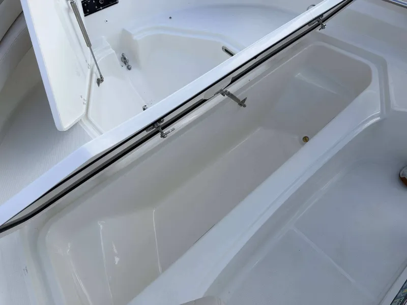 Slide: The Image of The image shows the storage compartment of a 2027 Boston Whaler 210 Montauk. - 25