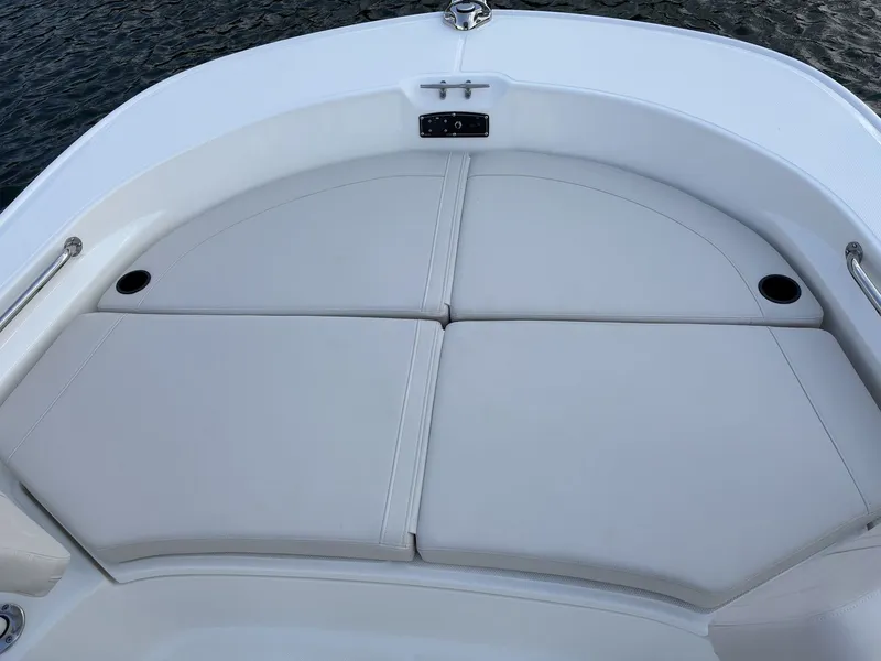 Slide: The Image of The image shows the bow area of a Boston Whaler 210 Montauk with cushioned seating. - 21