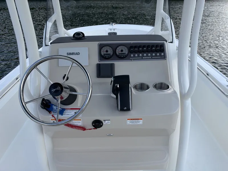 Slide: The Image of The image shows the helm of a 2027 Boston Whaler 210 Montauk with modern instruments. - 15