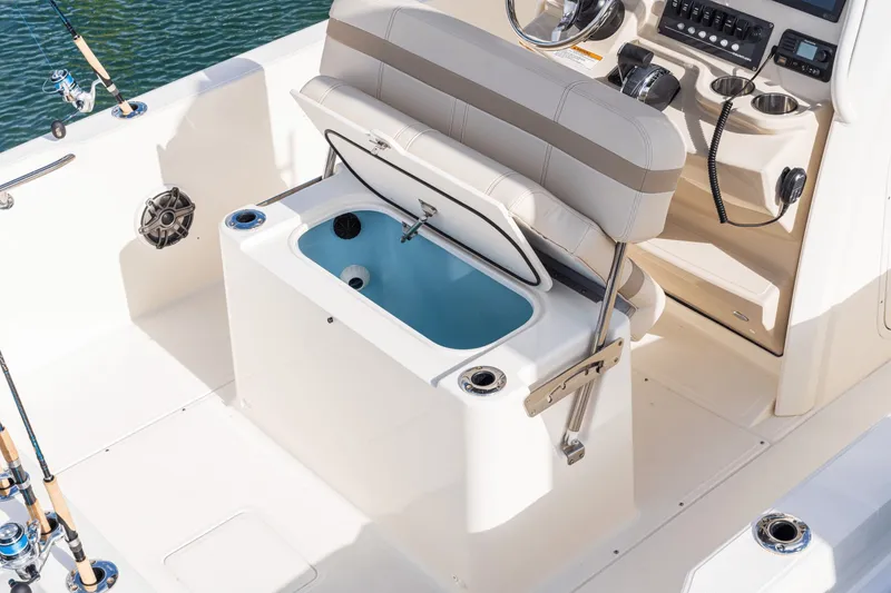 Slide: The Image of The image shows the cockpit of a Boston Whaler 220 Dauntless with an open storage compartment. - 40
