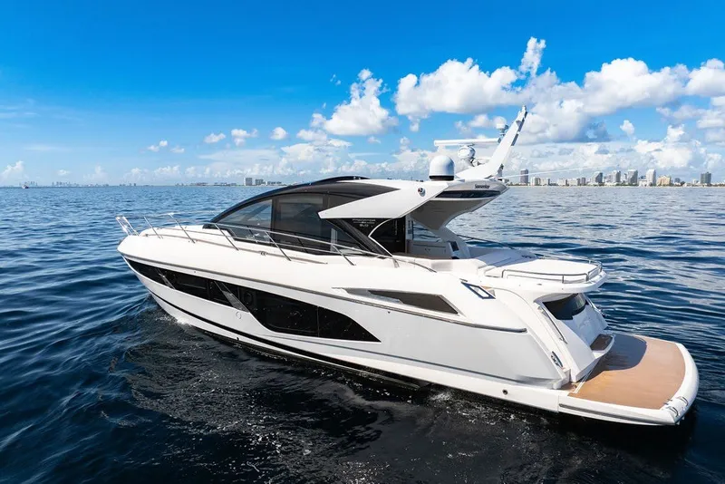 The Image of 2020 Sunseeker Predator 60 EVO yacht cruising on open water under a clear blue sky. - 0