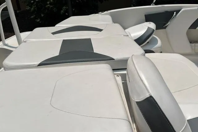 Slide: The Image of 2021 Chaparral 19 SSi OB boat interior with white and gray seating. - 8
