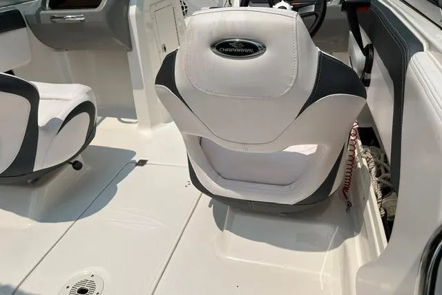Slide: The Image of 2021 Chaparral 19 SSi OB boat interior with white and black seating. - 7
