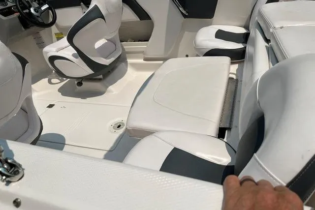Slide: The Image of 2021 Chaparral 19 SSi OB boat interior with white and black seating. - 12