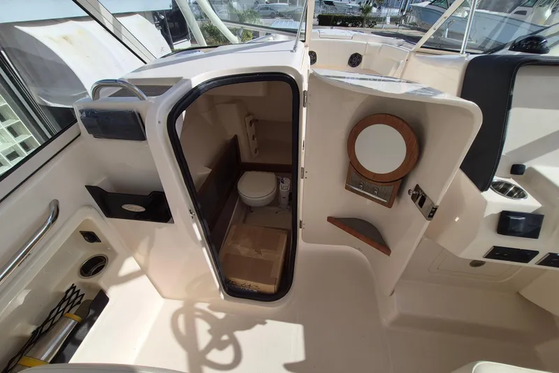 Slide: The Image of Interior view of 2026 Grady-White Freedom 275 boat, featuring a compact bathroom. - 11