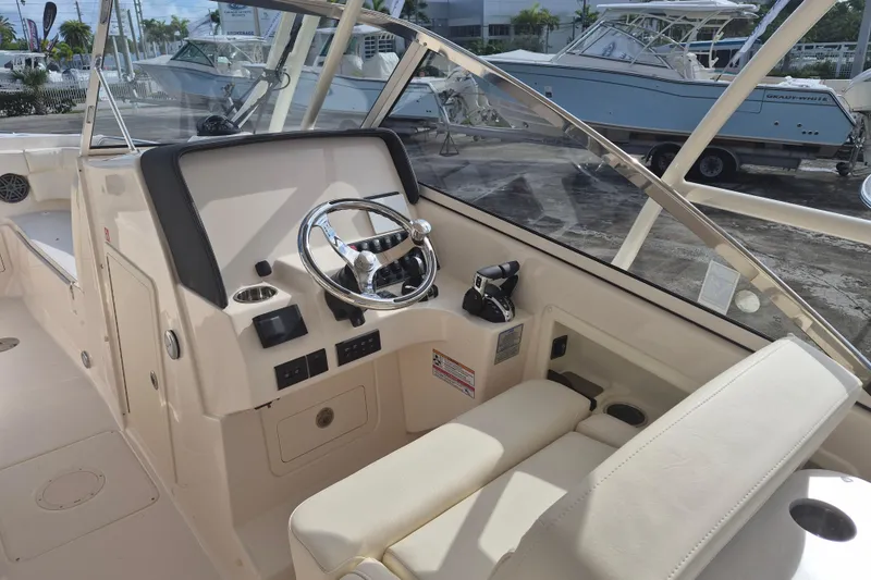 Slide: The Image of 2026 Grady-White Freedom 275 boat cockpit with steering wheel and controls. - 6