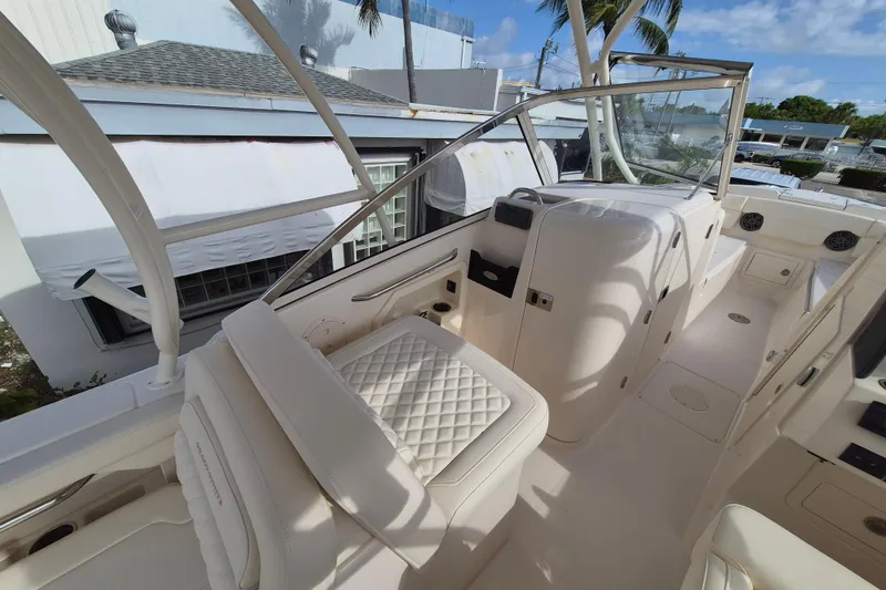 Slide: The Image of 2026 Grady-White Freedom 275 boat interior with white seating and modern design. - 7