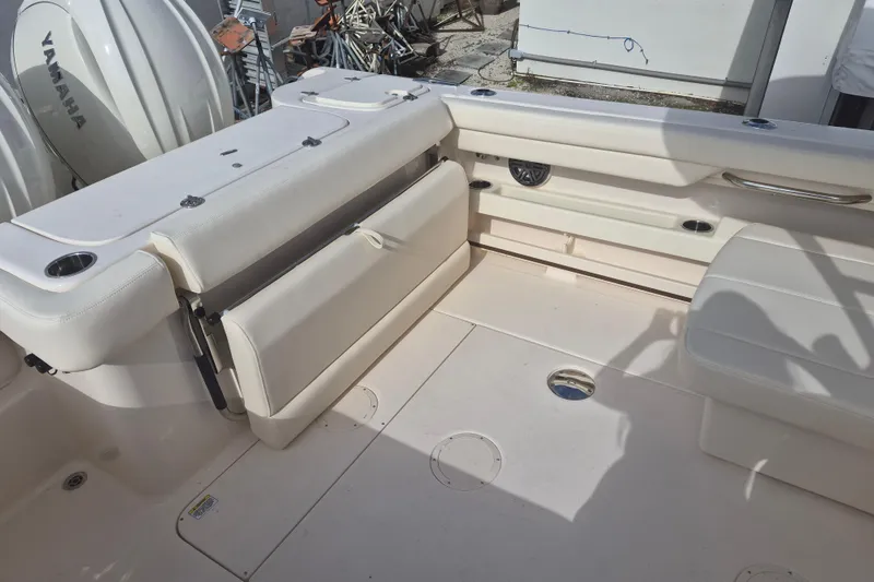Slide: The Image of 2026 Grady-White Freedom 275 boat interior with Yamaha engines, featuring seating and storage. - 14