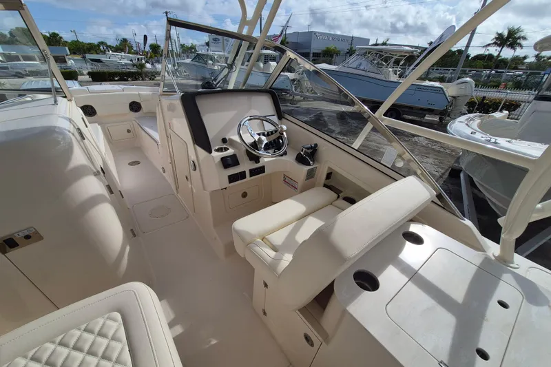 Slide: The Image of 2026 Grady-White Freedom 275 boat interior with steering wheel and seating. - 8