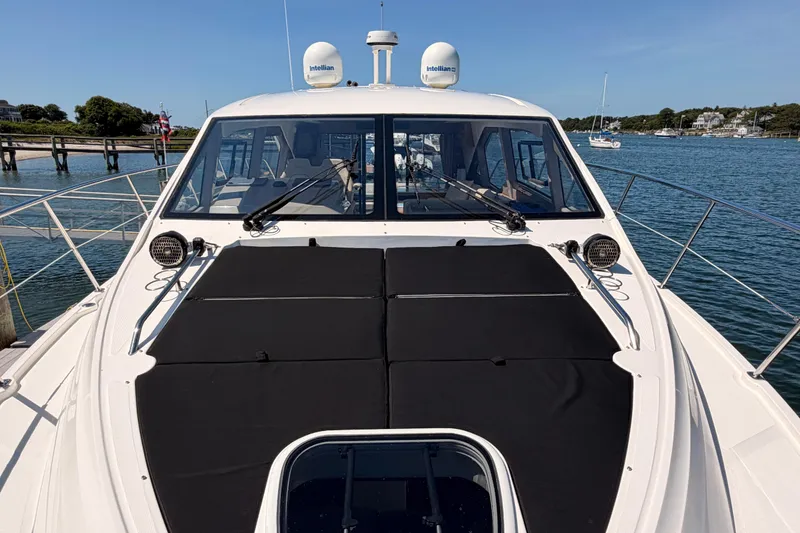 Slide: The Image of 2017 Sea Ray Sundancer 460 yacht docked, showcasing sleek design and spacious deck. - 6