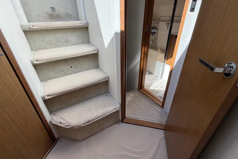 Slide: The Image of Interior view of 2017 Sea Ray Sundancer 460 yacht, featuring carpeted stairs and wooden doors. - 29