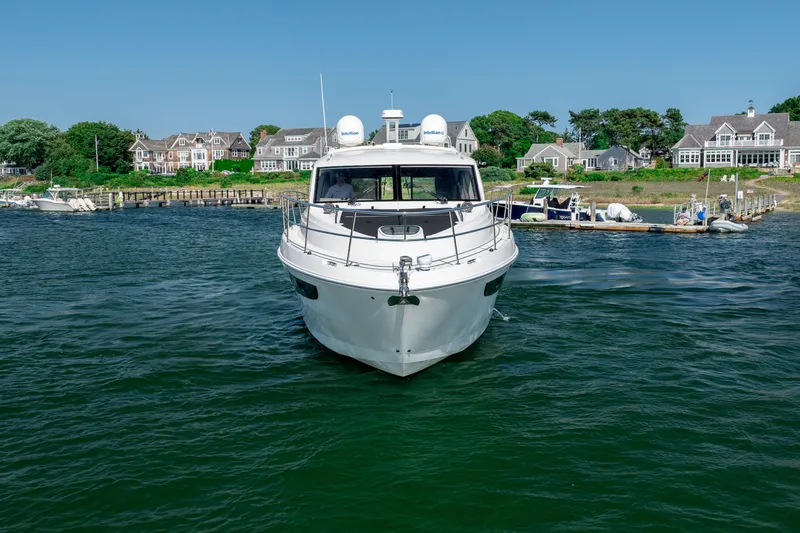 Slide: The Image of 2017 Sea Ray Sundancer 460 yacht cruising near coastal homes and docks. - 11