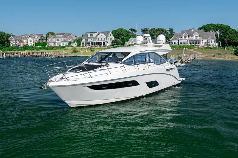 Slide: The Image of 2017 Sea Ray Sundancer 460 yacht cruising near waterfront homes. - 12