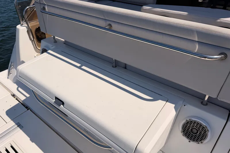 Slide: The Image of 2017 Sea Ray Sundancer 460 boat seating area with stainless steel railings and speaker. - 10