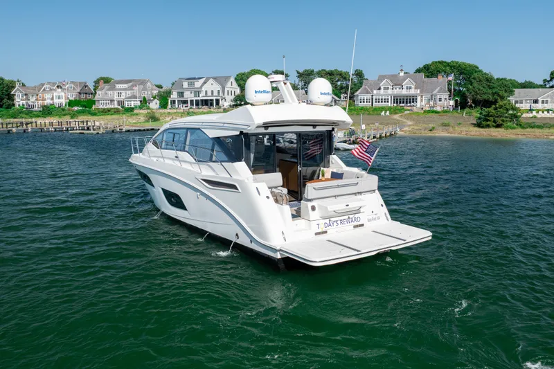 Slide: The Image of 2017 Sea Ray Sundancer 460 yacht cruising near waterfront homes. - 3