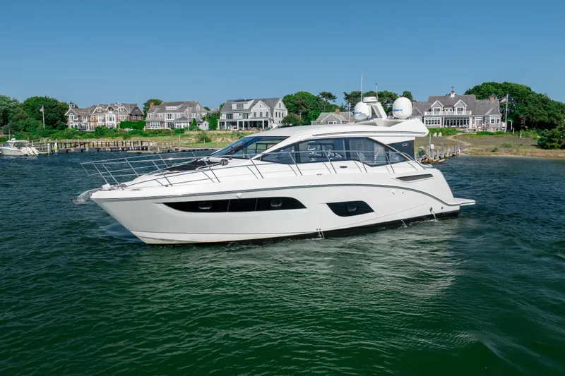 Slide: The Image of 2017 Sea Ray Sundancer 460 yacht cruising near waterfront homes. - 13