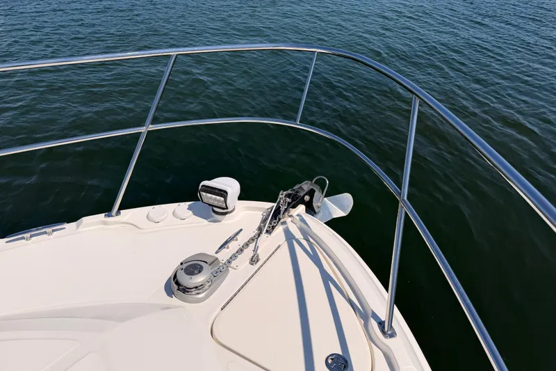 Slide: The Image of Bow of 2017 Sea Ray Sundancer 460 yacht with anchor and railing over water. - 9