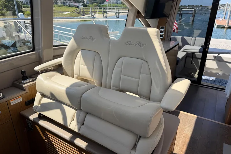 Slide: The Image of Interior of 2017 Sea Ray Sundancer 460 yacht with plush seating and scenic marina view. - 24